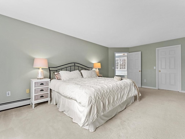 carpeted bedroom featuring a baseboard radiator and baseboards