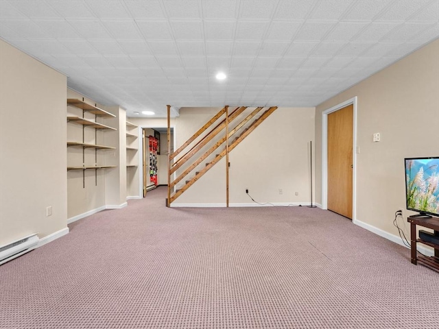 finished basement with a baseboard heating unit, baseboards, carpet, stairway, and recessed lighting