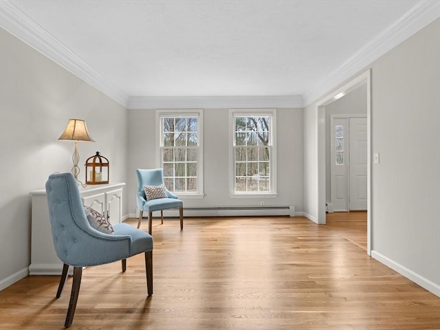 living area featuring ornamental molding, light wood-type flooring, baseboards, and a baseboard radiator