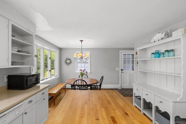 12 Wildwood Ter, Mattapoisett, MA 02739 - dining room with light wood-style floors and a chandelier