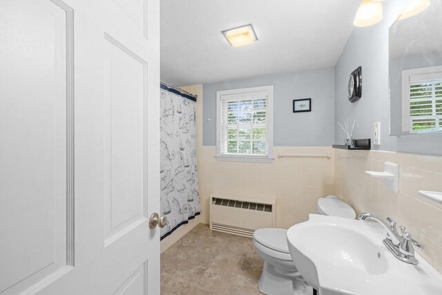 12 Wildwood Ter, Mattapoisett, MA 02739 - bathroom with radiator, tile walls, a shower with shower curtain, and a wainscoted wall