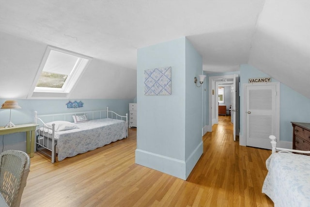 12 Wildwood Ter, Mattapoisett, MA 02739 - bedroom featuring vaulted ceiling, light wood finished floors, multiple windows, and a skylight