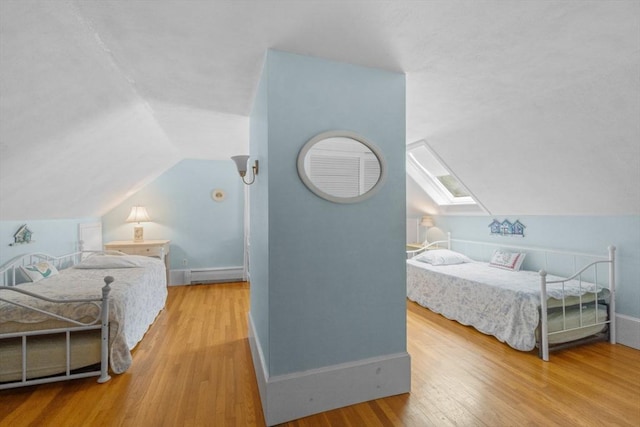 12 Wildwood Ter, Mattapoisett, MA 02739 - bedroom with baseboard heating, wood finished floors, vaulted ceiling, and a skylight