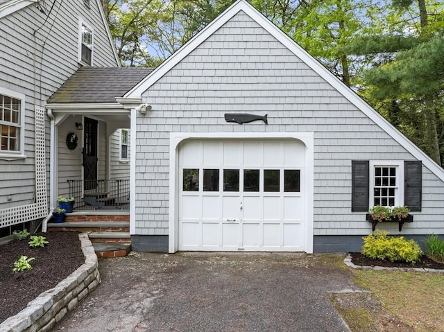 12 Wildwood Ter, Mattapoisett, MA 02739 - view of front facade featuring a shingled roof, driveway, and a garage