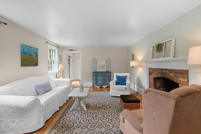 12 Wildwood Ter, Mattapoisett, MA 02739 - living area with wood finished floors, a brick fireplace, and baseboard heating