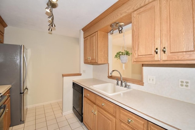 kitchen with freestanding refrigerator, a sink, black dishwasher, and light countertops
