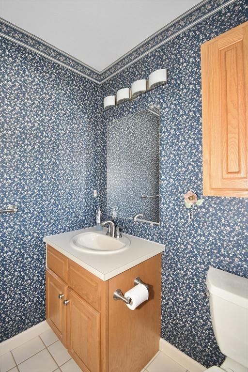 bathroom featuring toilet, wallpapered walls, tile patterned flooring, and vanity
