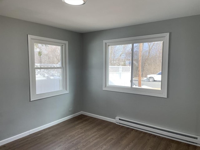 unfurnished room featuring a baseboard radiator and dark hardwood / wood-style floors