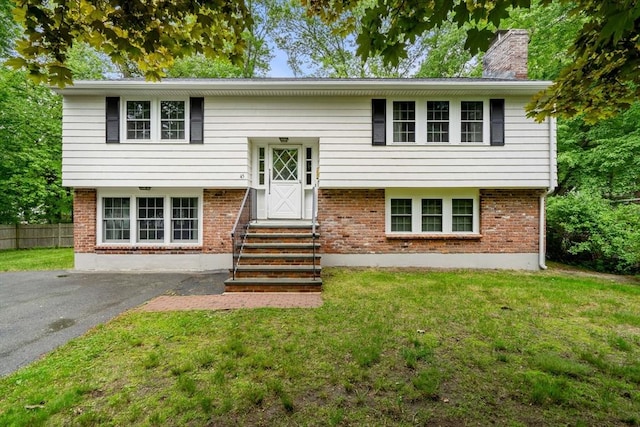45 Fairfield St, Maynard, MA 01754 - bi-level home with entry steps, a chimney, brick siding, and asphalt driveway