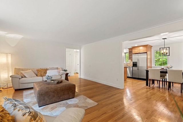45 Fairfield St, Maynard, MA 01754 - living area featuring a chandelier, light wood-style floors, ornamental molding, and baseboards