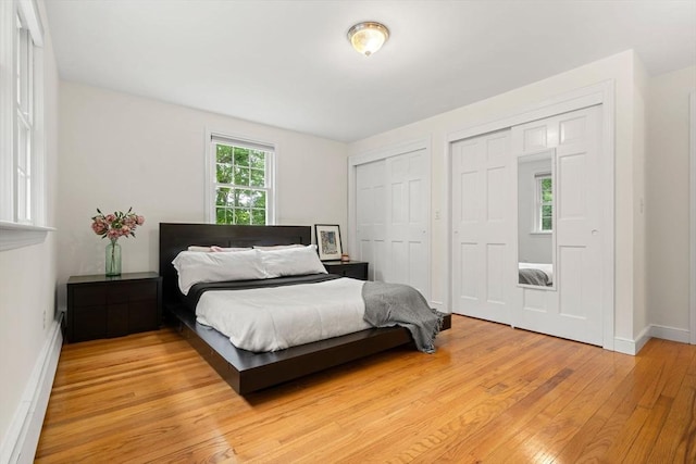 45 Fairfield St, Maynard, MA 01754 - bedroom with light wood finished floors, multiple closets, baseboards, and baseboard heating