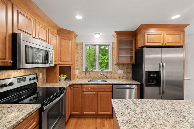 45 Fairfield St, Maynard, MA 01754 - kitchen with appliances with stainless steel finishes, a sink, light wood finished floors, light stone counters, and recessed lighting