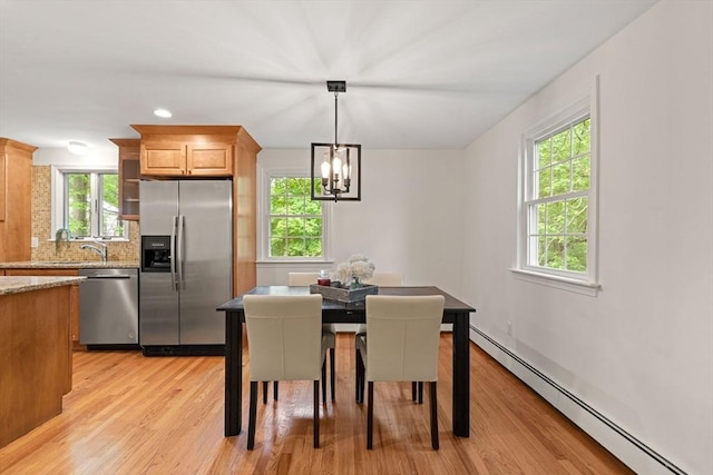 45 Fairfield St, Maynard, MA 01754 - dining room featuring a baseboard radiator, light wood finished floors, a chandelier, and recessed lighting