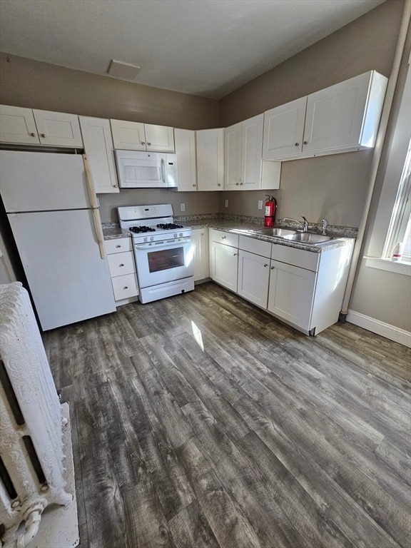 kitchen with white cabinets, white appliances, and dark wood-type flooring