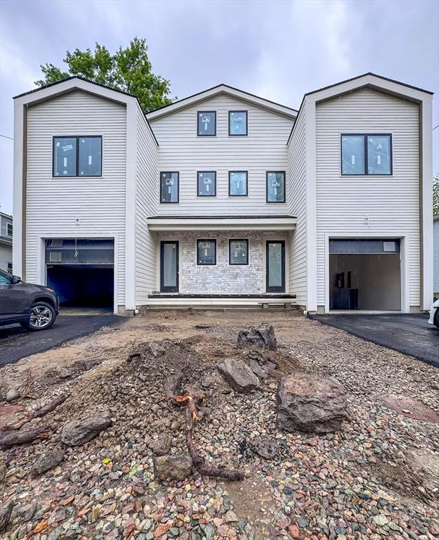 156-158 Langley Rd Unit 1, Newton, MA 02459 - view of property featuring asphalt driveway and a garage