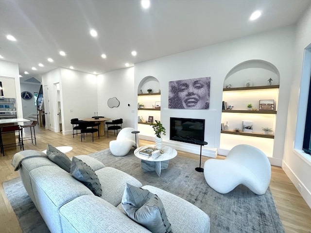 156-158 Langley Rd Unit 1, Newton, MA 02459 - living room featuring light wood-style flooring, recessed lighting, and a glass covered fireplace