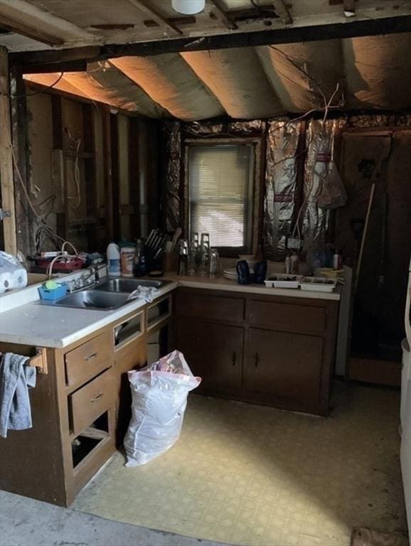 kitchen with light countertops, a sink, and light floors