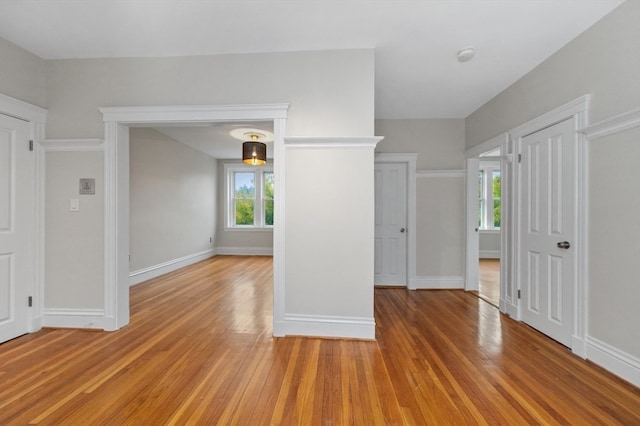 spare room with a healthy amount of sunlight and light hardwood / wood-style flooring