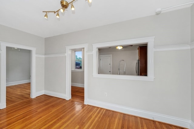 unfurnished room with hardwood / wood-style flooring