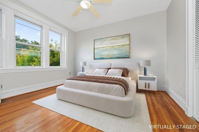 bedroom with hardwood / wood-style flooring and ceiling fan