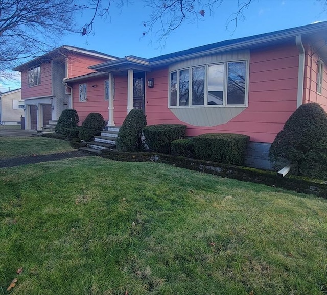 view of front of house with a garage and a front yard