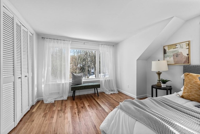 bedroom with light wood-type flooring and baseboards