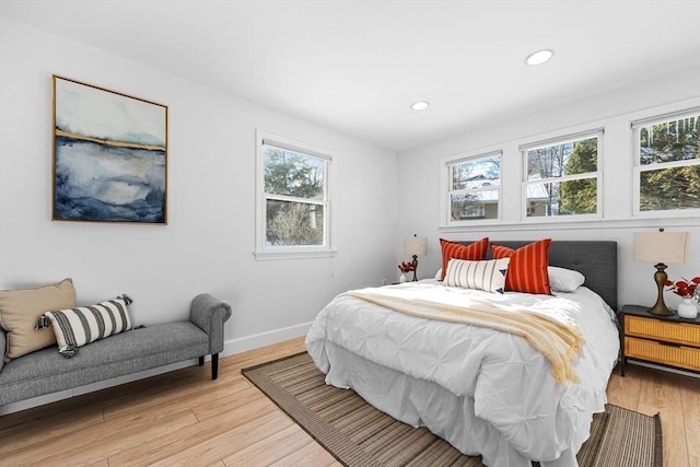 bedroom with recessed lighting, baseboards, and light wood finished floors