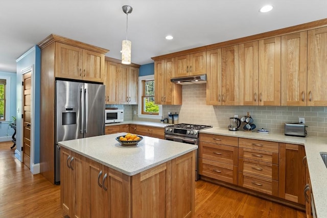 18 Hill St, Lexington, MA 02421 - kitchen featuring stainless steel appliances, under cabinet range hood, wood finished floors, decorative backsplash, and recessed lighting