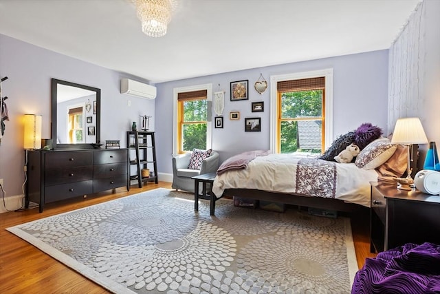 18 Hill St, Lexington, MA 02421 - bedroom with a wall mounted AC, wood finished floors, and a chandelier