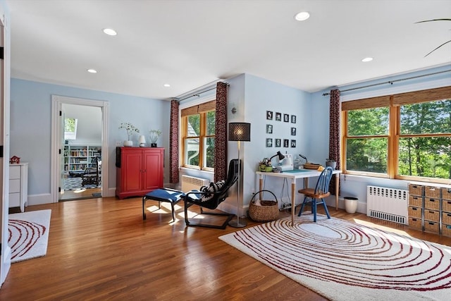 18 Hill St, Lexington, MA 02421 - living area with radiator heating unit, wood finished floors, recessed lighting, and baseboards