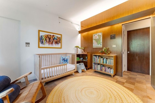 bedroom featuring wood walls