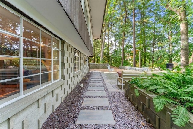 view of side of home featuring a patio area