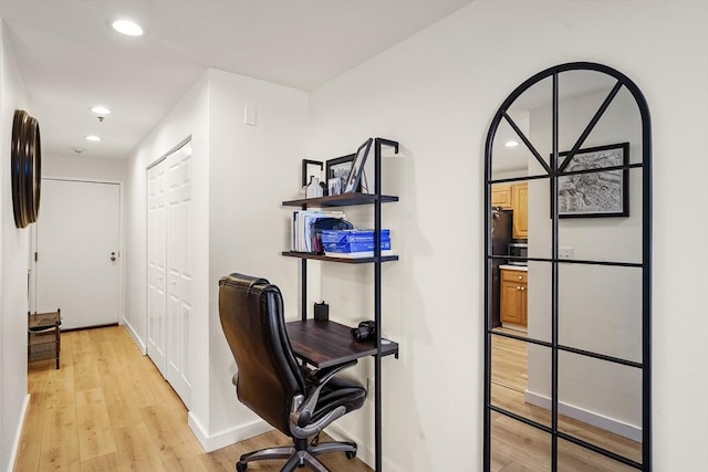 office space with light wood-style flooring, recessed lighting, and baseboards