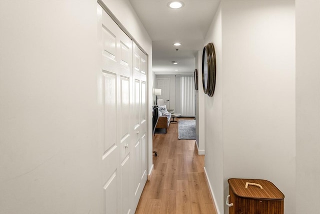 corridor with recessed lighting, light wood-style flooring, and baseboards