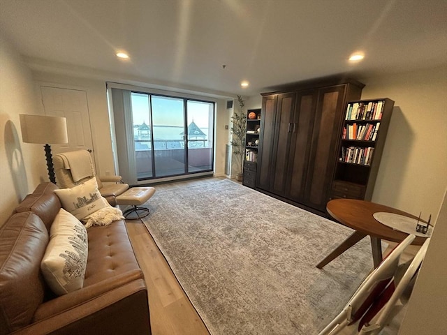 living room with light wood-type flooring and recessed lighting