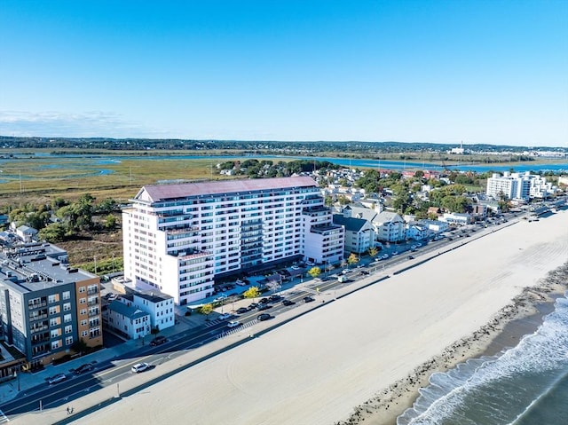 bird's eye view of apartment complex / building and expansive coastline