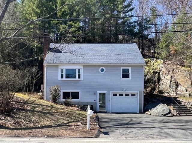 197 Winn St, Burlington, MA 01803 - colonial house featuring a shingled roof, an attached garage, and driveway