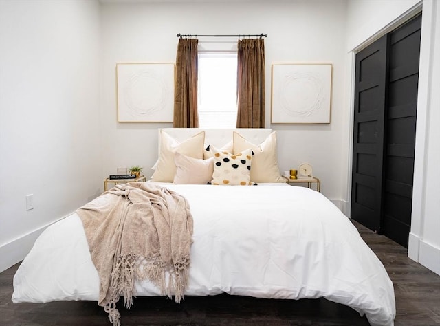 bedroom with dark wood-style floors