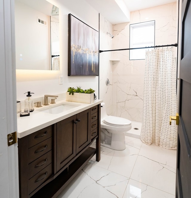 bathroom featuring walk in shower, vanity, and toilet