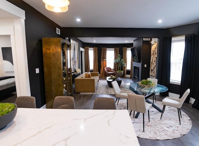 dining room featuring recessed lighting, a wealth of natural light, wood finished floors, and a fireplace