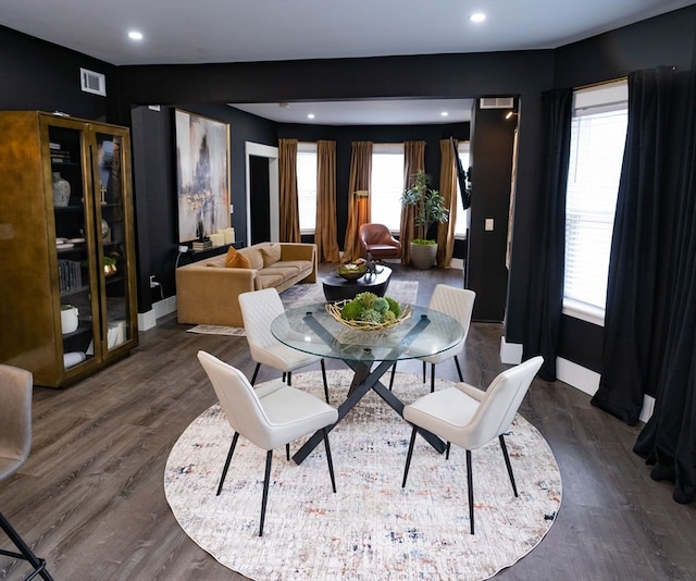 dining area featuring plenty of natural light and dark hardwood / wood-style flooring