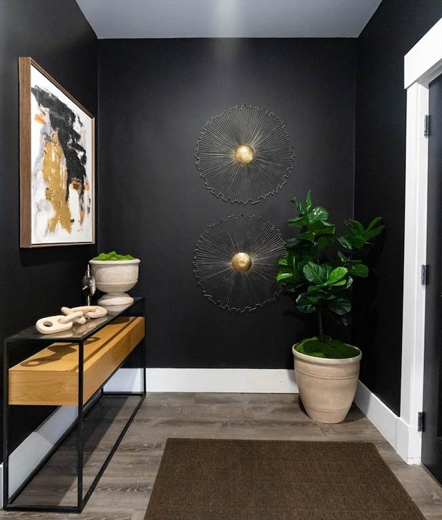 interior space with baseboards and wood finished floors