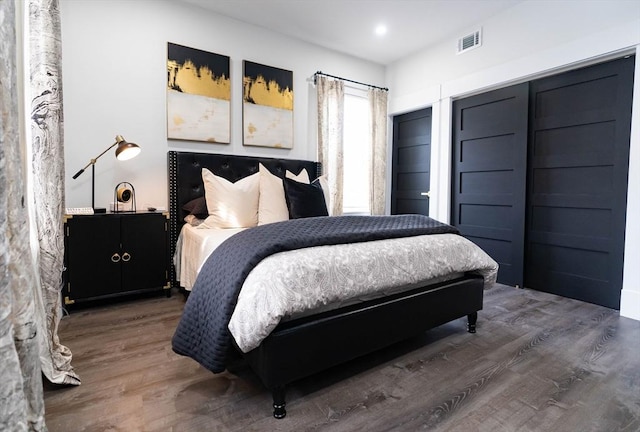 bedroom with wood finished floors and visible vents