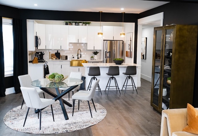 dining space featuring hardwood / wood-style flooring and sink