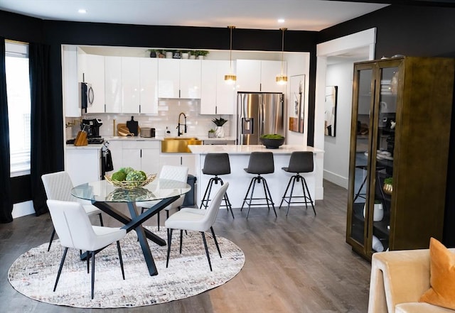 dining space featuring baseboards, recessed lighting, and dark wood-type flooring