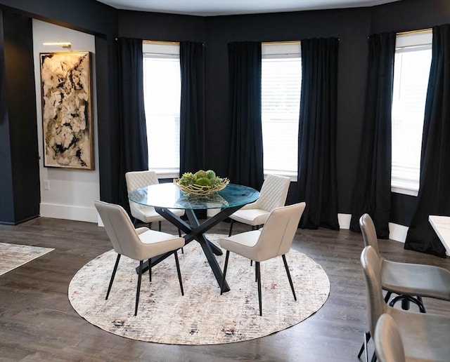 dining area featuring plenty of natural light, baseboards, and wood finished floors