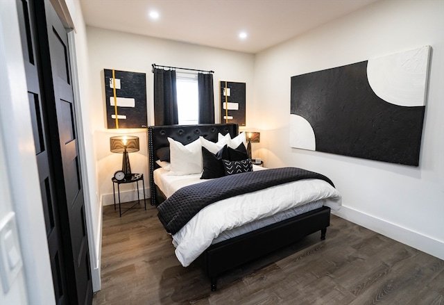 bedroom with dark hardwood / wood-style floors