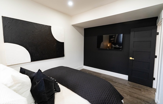 bedroom with dark hardwood / wood-style flooring