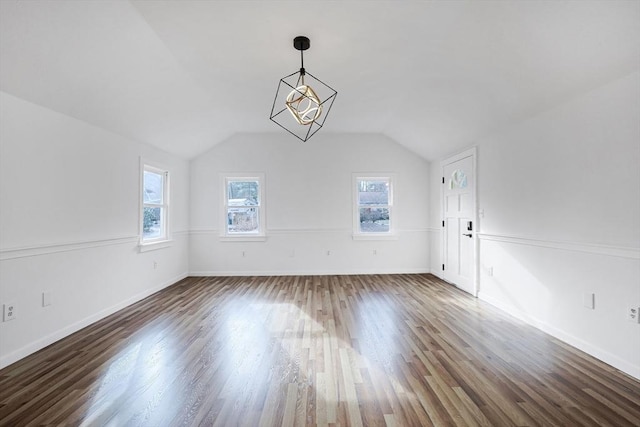 interior space with dark hardwood / wood-style flooring, an inviting chandelier, and lofted ceiling