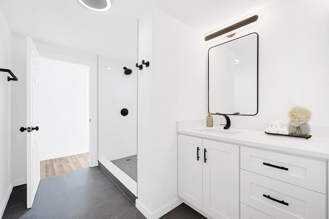 bathroom featuring tile patterned floors, vanity, and walk in shower